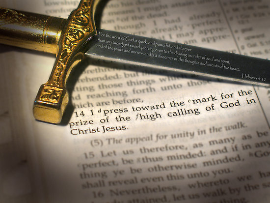 Sword on Bible with highlighted verse text.