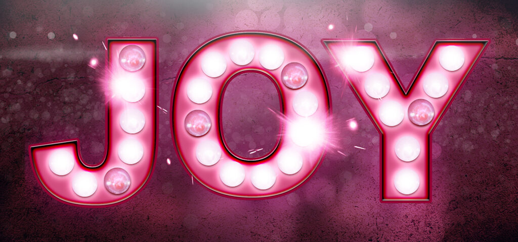 Glowing "Joy" sign with bright lights.