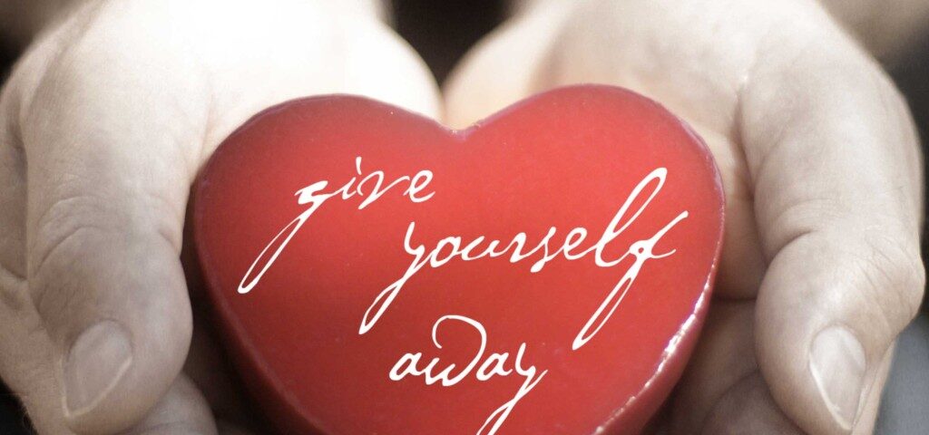 Hands holding heart with "give yourself away.