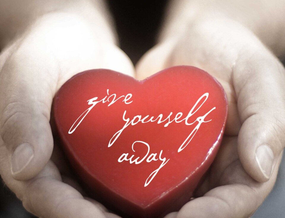 Hands holding heart with "give yourself away.