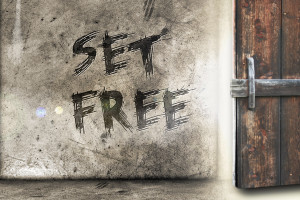 Set Free" graffiti beside wooden door.