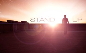 Silhouette standing against a glowing sunset.