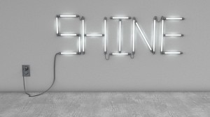 Neon lights spelling "SHINE" on wall.