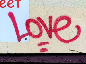 Red "Love" graffiti on a wall.