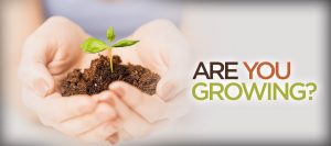 Hands holding sprout with "Are You Growing?