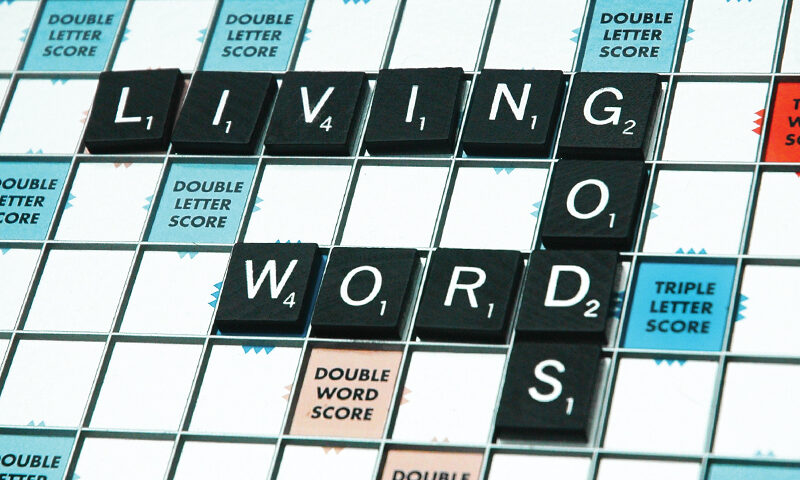 Scrabble board with words "Living God's Words".