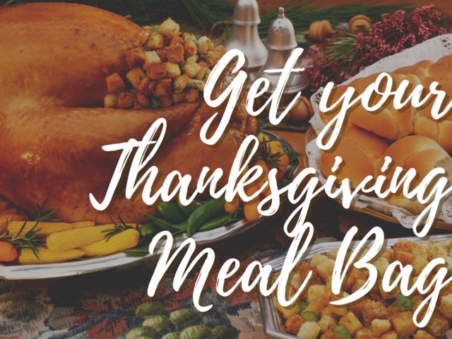 Festive Thanksgiving meal with turkey, corn, and sides.