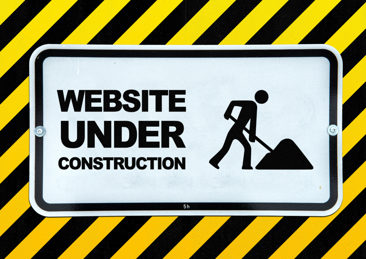 Website under construction sign with caution stripes.