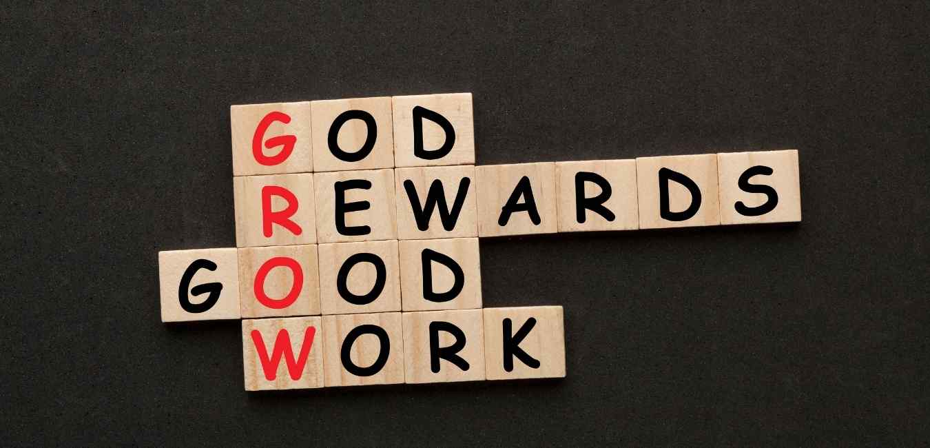 Scrabble tiles forming motivational words about growth and effort.