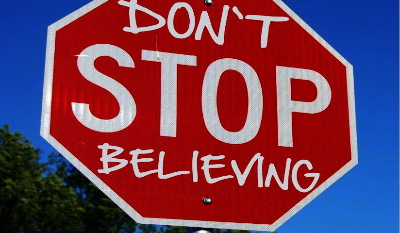 Stop sign altered to say 'Don't Stop Believing'.