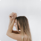 Profile of a woman with long hair against a white background.